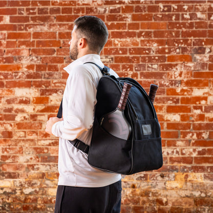 Guy wearing black pickleball backpack